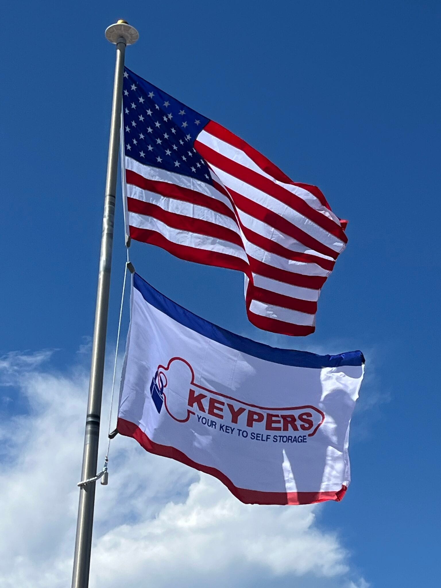 Keypers Storage flag featuring the brand logo and colors, symbolizing organization and storage solutions.